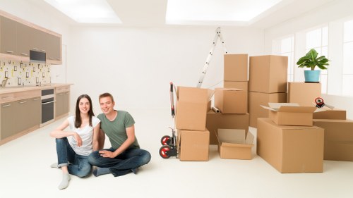 Packed moving boxes and labeled items ready for house removals in Plaistow